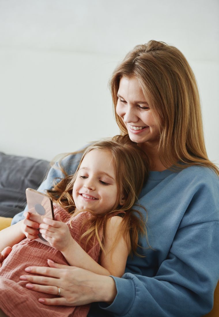 Parent and child looking at a phone together