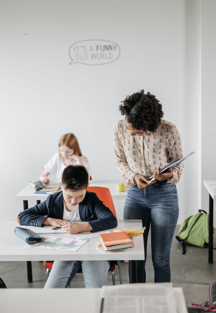 Teacher helping a student in class